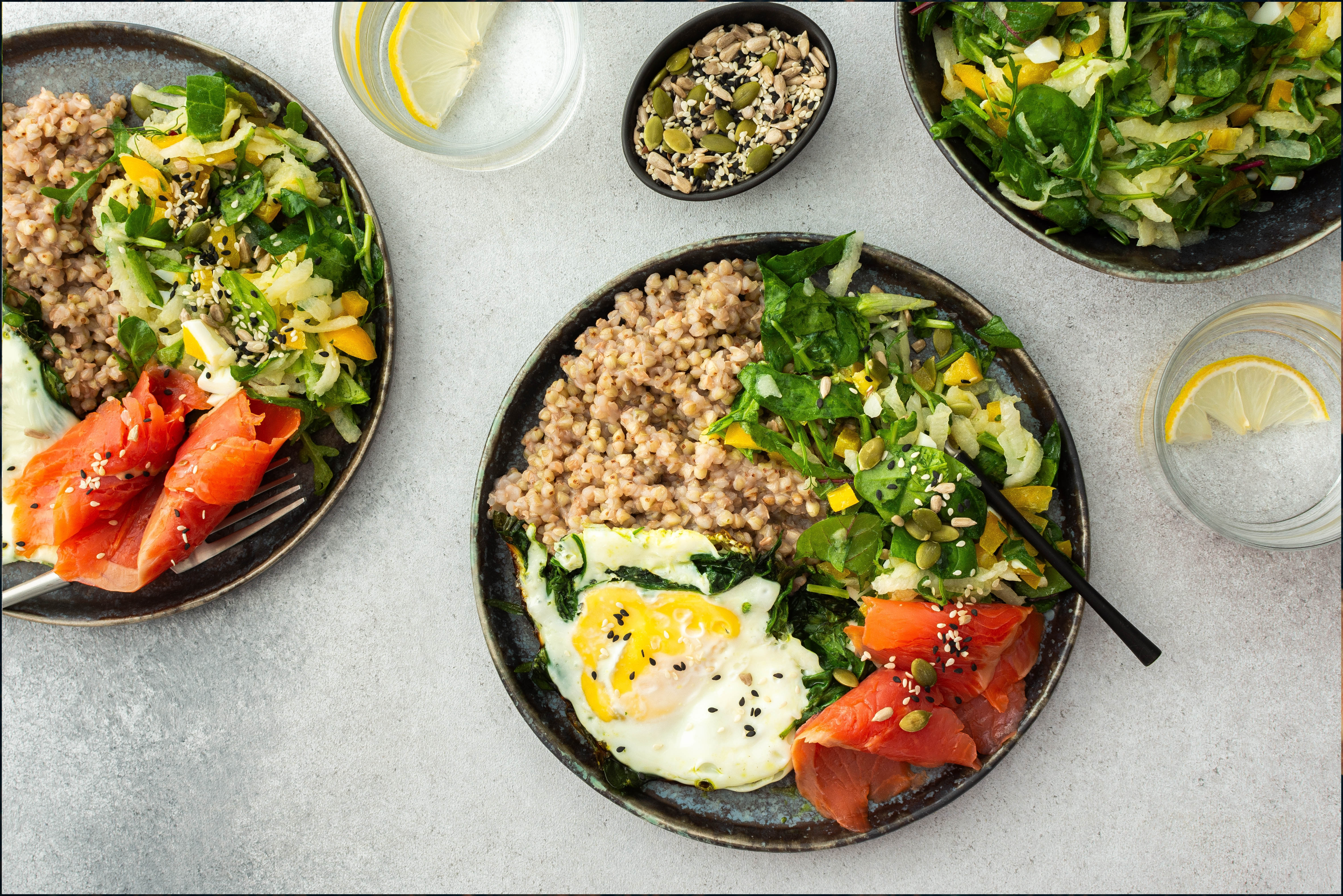 Healthy balanced breakfast with grains, vegetables, eggs, smoked salmon